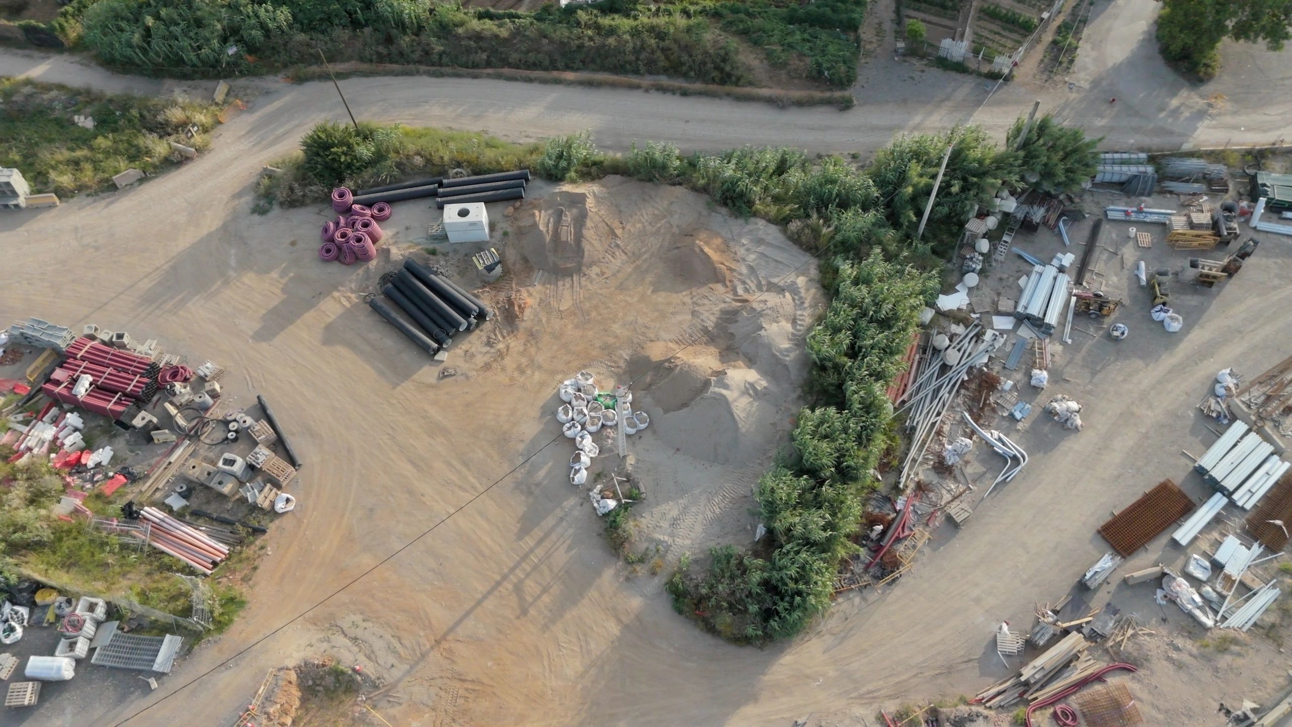 Aerial construction progress image showing site layout and storage areas
